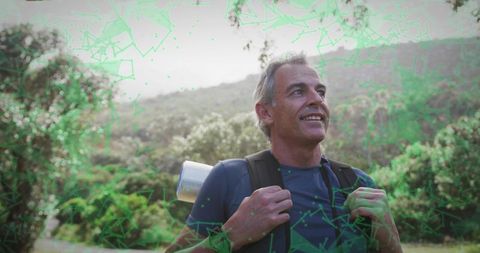 Middle-aged Man Hiking Through Lush Hillside With Backpack and Sleeping Pad
