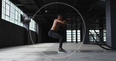 Man exercising indoors with pushups in urban gym setting