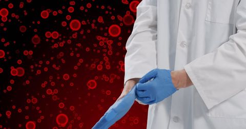 Doctor Wearing Gloves with Red Cells Background
