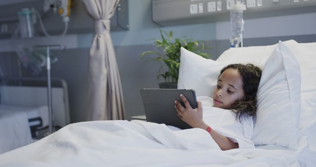 Young Girl Using Tablet While Lying in Hospital Bed - Download Free Stock Images Pikwizard.com