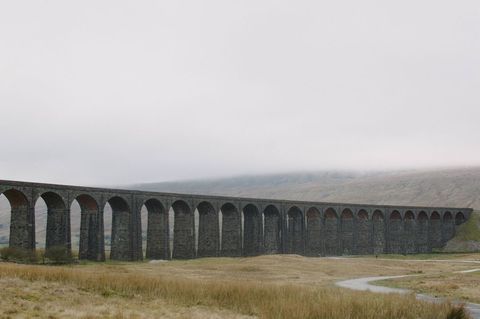 Historic Stone Viaduct amidst Misty Landscape