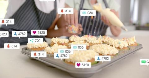 Baking cupcakes together with social media notification overlays and colorful sprinkles