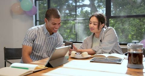 Cheerful colleagues celebrating in festive office
