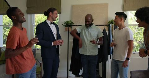 Friends Celebrating at Home with Drinks and Smiles