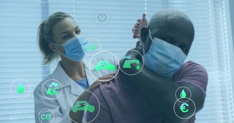 Physical therapist assisting patient with shoulder rehab during health pandemic