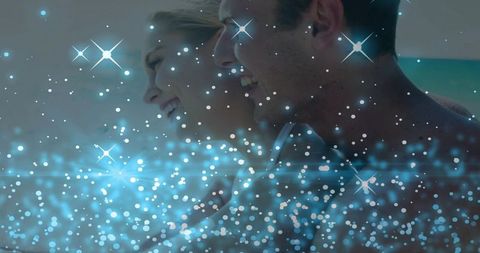 Laughing Couple Leaning at Waterline with Sparkling Blue Bokeh Romantic Beach Glow