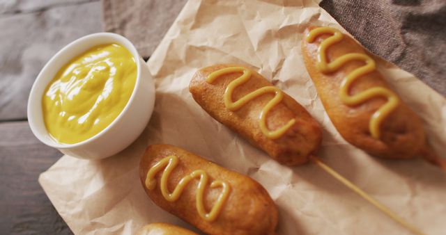 Image of corn dogs with dip on a wooden surface. food, cuisine and catering ingredients.