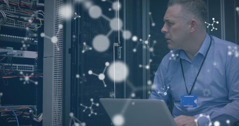 Technician analyzing data with molecule overlay in server room
