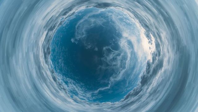 Dynamic swirling cloud vortex in expansive sky tunnel