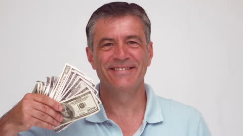 Happy Mature Man Showing Success with US Dollars