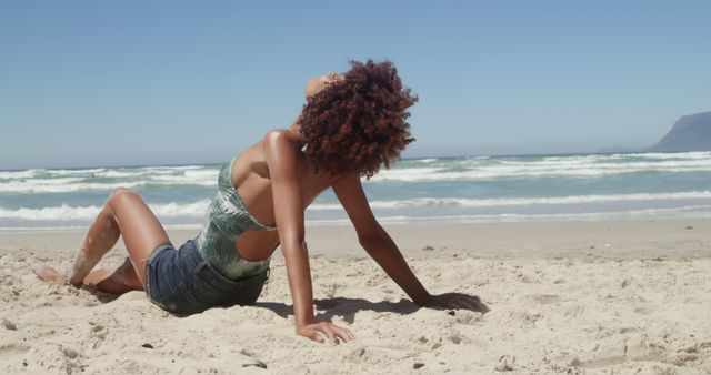 Woman relaxing on a sunny beach - Download Free Stock Images Pikwizard.com