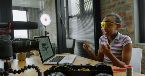 Teen Adapt Tech Enthusiast Recording Vlog in Bright Workspace