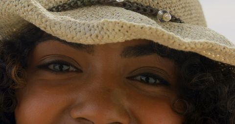 Close-up of Smiling African American Woman in Sun Hat at Beach