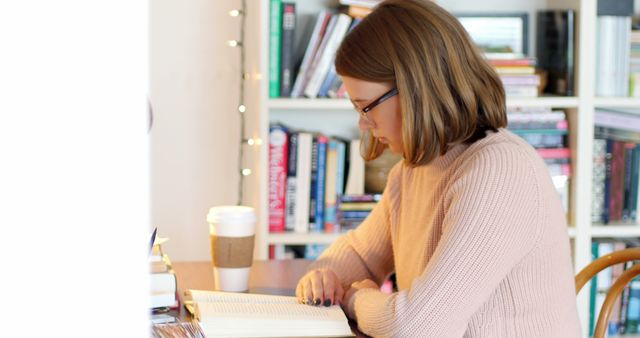 Woman Reading in Cozy Home Library with Coffee Cup - Download Free Stock Images Pikwizard.com