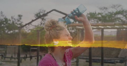 Woman refreshing after outdoor workout at sunset