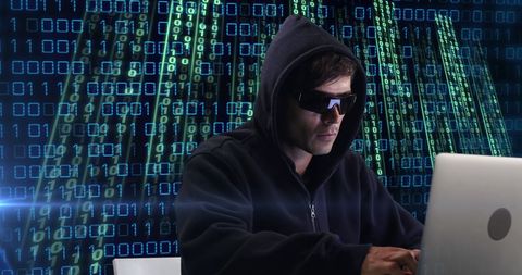 Hacker in Hoodie Working on Laptop with Digital Code Background - Download Free Stock Images Pikwizard.com