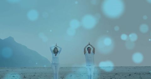 Caucasian Couple Practicing Yoga on Tranquil Beach with Light Effects