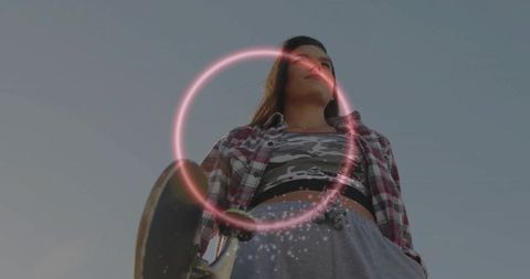 Youthful Skateboarder with Neon Ring Effect Wearing Comfortable Streetwear