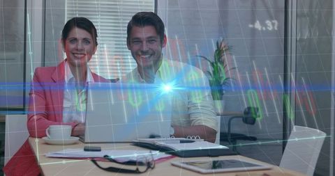 Professionals Analyzing Financial Data on Laptop in Office