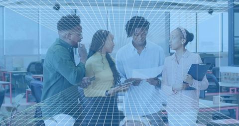 Collaborating team reviewing documents and devices with digital wireframe overlay in modern workspac