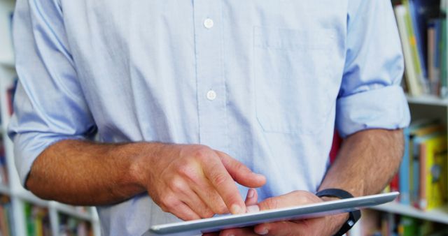 Man Using Tablet in Library for Research and Studies - Download Free Stock Images Pikwizard.com