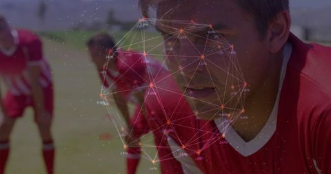 Focused soccer player training with digital network overlay for data-driven team strategy