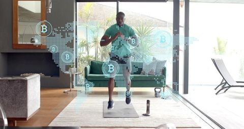 Man doing high-knee workout at home with kettlebell and bitcoin holograms for fitness tech