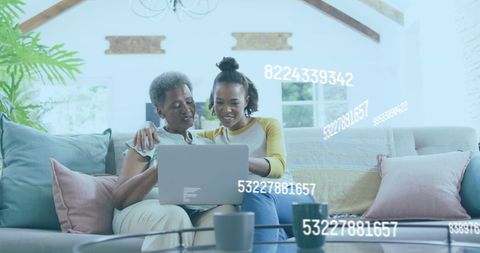 Two African American Women Engaging with Digital Finances on Laptop