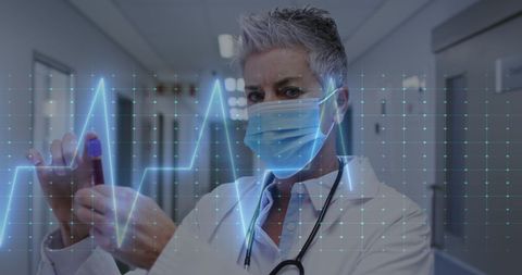 Doctor analyzing vial with heartbeat graphic in hospital