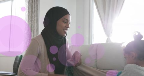 Mother and Daughter Sharing Joyful Moments on Sofa