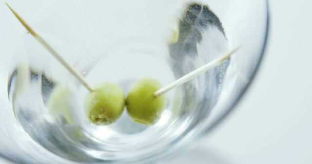 Two Green Olives in Empty Glass with Toothpicks Close-up - Download Free Stock Images Pikwizard.com