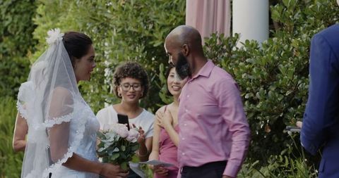 Bride smiling holding bouquet wedding ceremony