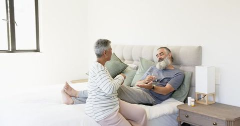 Senior Couple Relaxing on Bed in Modern Cozy Bedroom