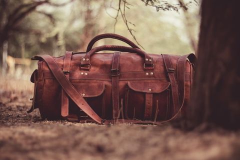 Rustic leather travel duffel bag outdoors