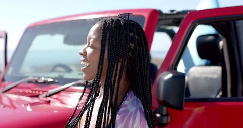 Joyful Young Woman Reflecting Beachside Adventure Enjoying Freedom