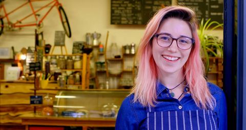 Smiling Barista in Trendy Urban Cafe with Cozy Ambiance