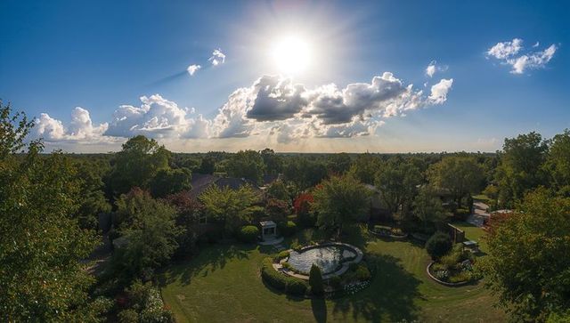 Serene backyard garden with circular pond and pavilion