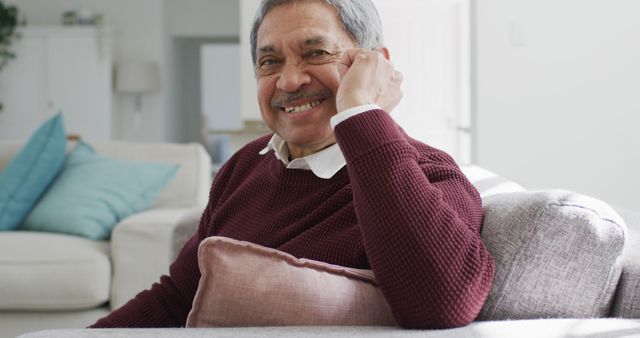 Elderly Man Relaxing On Sofa Smiling at Camera - Download Free Stock Images Pikwizard.com