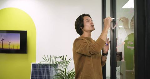 Man designing renewable solutions in modern eco-friendly office