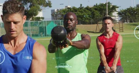 Men Exercising with Kettlebells on Outdoor Sports Field