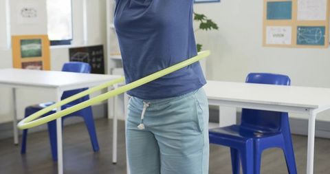 African teen using hula hoop in classroom promoting movement fitness and classroom play