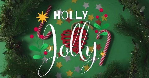 Holly jolly holiday flatlay with candy canes, pine garland, stars and ornaments