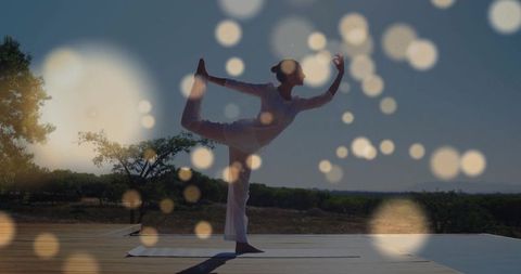 Woman Practicing Yoga Outdoors Beneath Sunny Skies