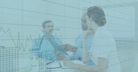 Doctors Analyzing Line Graph in Hospital Meeting Room