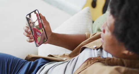 Relaxed Man Watching Soccer Game on Smartphone