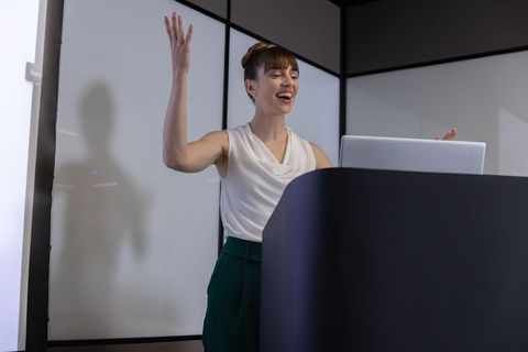 Confident Businesswoman Delivering Presentation at Podium