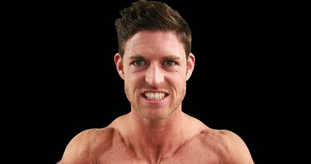 A young Caucasian man is featured against a black background, with copy space. His intense expression and muscular build suggest he might be an athlete or fitness enthusiast.