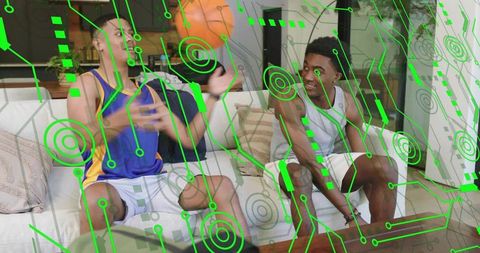 Friends catching basketball on couch while laughing with futuristic circuit overlay