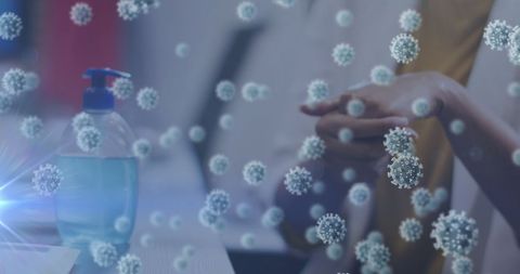 Woman sanitizing hands surrounded by virus cells