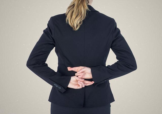 Businesswoman with fingers crossed behind back for luck or deception - Download Free Stock Photos Pikwizard.com